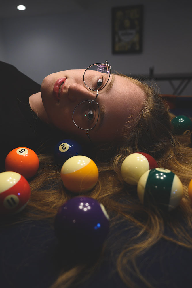 Bobby Kenny III photo of a female model and billiard balls on a pool table