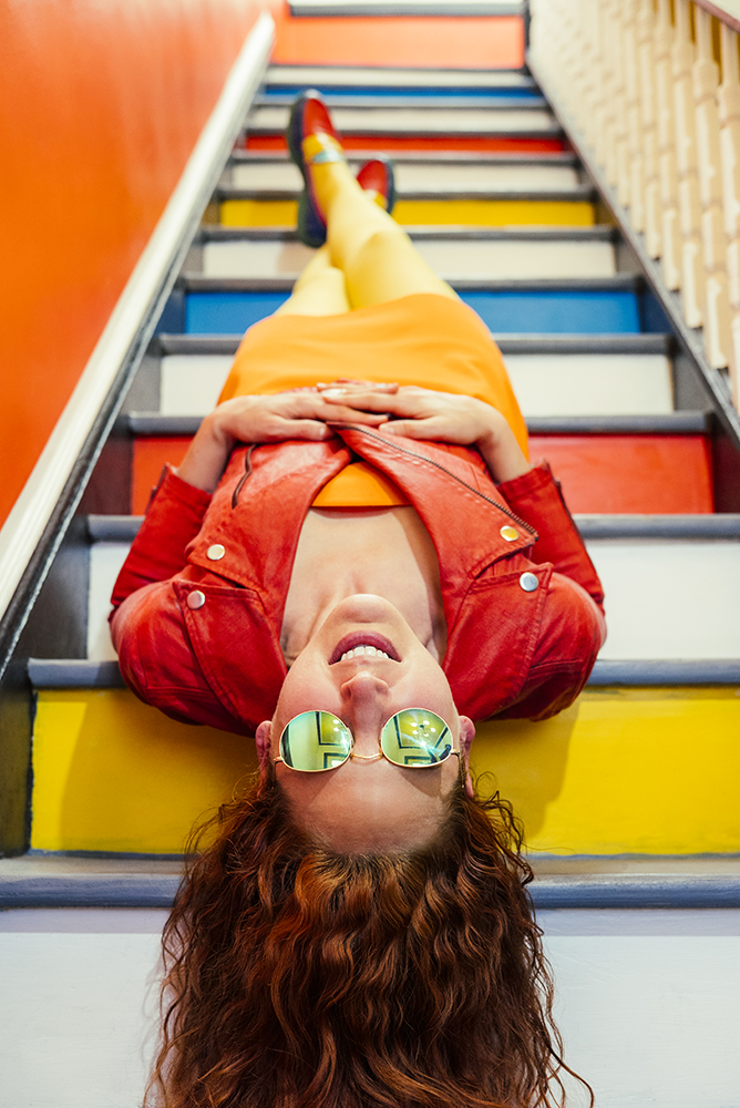 Gabriela Herman photo of a woman lying on colorful stairs